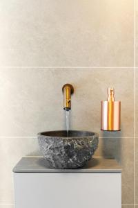 a sink with a faucet on top of a counter at Horizon Suite at Sea in Vlissingen +38 photos