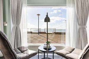 a living room with a window with a view of the ocean at Horizon Suite at Sea in Vlissingen
