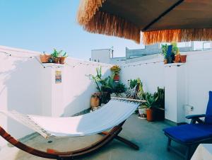 a hammock on a balcony with plants at Le volte di Umberto Scirocco in Sogliano Cavour