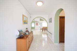 a living room with white walls and an archway at Anna in Drage +174 photos