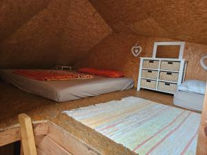 a room with two beds and a rug in a attic at Brīvdienu māja Mētriņi in Ķekava +20 photos
