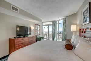 a bedroom with a large bed and a television at Dunes Village in Myrtle Beach +115 photos