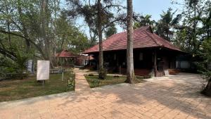 a building with a sign in front of it at Havmi Wellness Resort in Kumarakom +33 photos