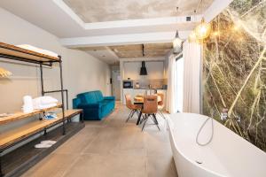 a bathroom with a tub and a dining room at Del Mar Court in Marsalforn +67 photos