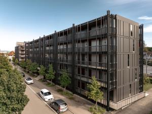 an apartment building with cars parked in front of it at b20 - serviced apartments bern ag in Bern
