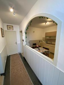 a kitchen with an archway leading into a room at Appartement Kylie in Néris-les-Bains