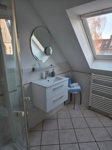 a bathroom with a sink and a mirror at Appartementhaus "Helgoland" in Cuxhaven +18 photos