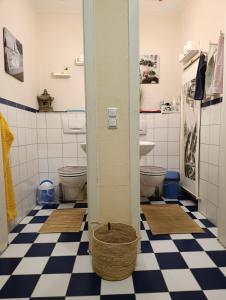 a bathroom with two toilets and a basket on the floor at Einzigartige Studio-Atmosphäre in Bamberg +24 photos