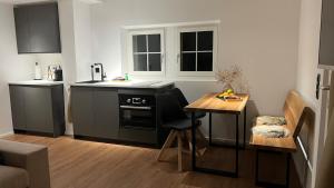 a kitchen with a stove and a table in it at Gottlieber Rausch in Gottlieben