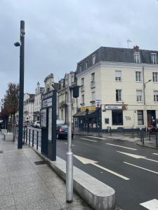 a city street with a bus stop on the side of the road at Hôtel Du Mans in Angers +14 photos