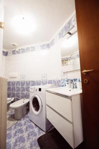 a bathroom with a washing machine and a toilet at Ca' del Giuli in Maslianico +26 photos