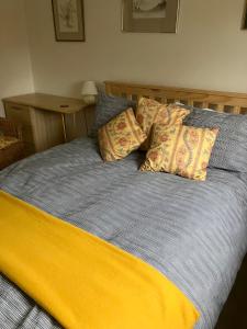 a bed with two pillows on top of it at 18 Wixon Path in Buckinghamshire