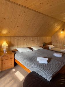 a bedroom with a large bed with a wooden ceiling at KOMFORT in Berehove