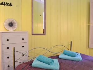 a bedroom with a bed with two blue pillows on it at Beach Retreat - Ukc2322 in St Ives +8 photos