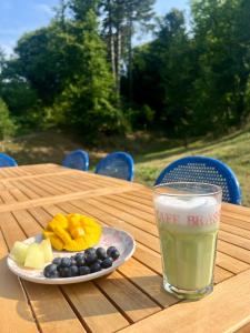 a plate of fruit and a glass of milk on a table at Il lupo e il filosofo b&b in Pontinvrea