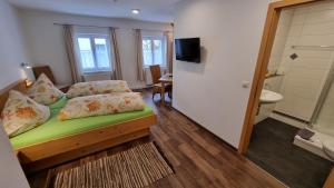 a small room with a bed and a bathroom at Mühldorfer Hof in Altötting