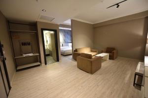 a living room with a couch and a bedroom at Anemon Grand Şanlıurfa in Göktepe