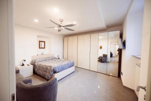a bedroom with a bed and a ceiling fan at Residenza Caterina in Maslianico