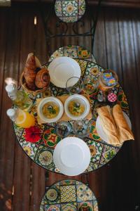 a table with plates of food and bread on it at Banana Cottage Ecolodge & Spa in Le Gosier