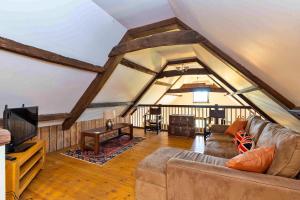 a living room with a couch and a tv at Finest Retreats - Fletland Mill in Stamford