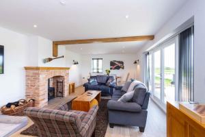 a living room with two couches and a fireplace at Finest Retreats - The Holt in Stamford