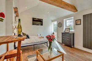 a living room with a couch and a table at Finest Retreats - The Den in Stamford