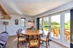 a dining room with a wooden table and chairs at Finest Retreats - The Roost in Stamford