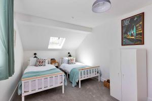 a bedroom with two beds in a attic at Finest Retreats - The Roost in Stamford