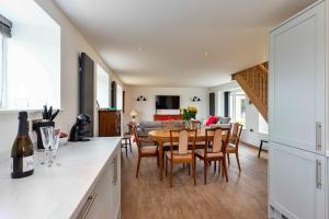 a kitchen and dining room with a table and chairs at Finest Retreats - The Warren in Stamford