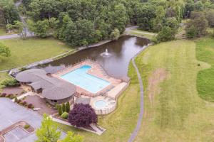 an aerial view of a pond with a swimming pool at Pet-Friendly w Fire Pit Grill & Resort Access in Hedgesville
