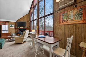 a living room with a table and chairs at Pet-Friendly w Fire Pit Grill & Resort Access in Hedgesville