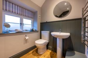 a bathroom with a toilet and a sink and a mirror at 2 Bed in Selside oc-ds1067 in Selside +21 photos