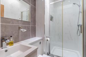 a bathroom with a sink and a glass shower at 4 Bed in Wonastow oc-k29425 in Wonastow +19 photos