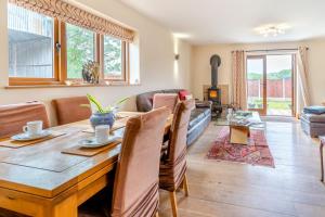 a dining room and living room with a wooden table at 4 Bed in Wonastow oc-k29425 in Wonastow