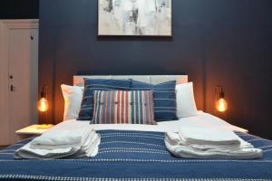 a bedroom with a bed with towels on it at Manchester Ashton Suites in Ashton under Lyne