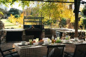 a table set up for a meal in a garden at Wishome-Finca de película en el campo con piscina privada in Mejorada +16 photos