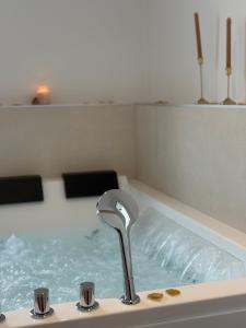 a bath tub with a water faucet in it at BoomCoeur in Niort +11 photos