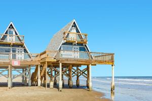 a house on a pier on the beach at Iconic A Frame Sleep Over the Gulf in Surfside Beach