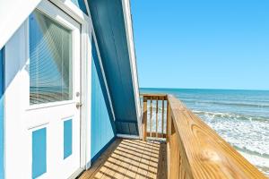 a door to a house on the beach at Iconic A Frame Sleep Over the Gulf in Surfside Beach