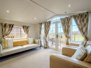 a living room with two couches and large windows at The Orchard - Uk7111 in Alloa