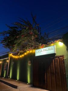 a sign on the side of a building with lights at HOSTAL CASA PALMA in Ríohacha