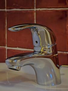 a bathroom sink with a chrome water faucet at Hotel Chalet d'Oulx in Oulx +76 photos