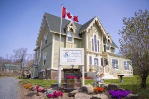 a house with a sign in front of it at Seabank House Bed and Breakfast Aloha in Pictou