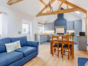 a living room with a blue couch and a table at 1 Bed in Taunton oc-80693 in North Curry
