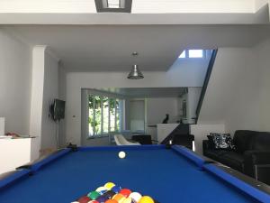 a living room with a pool table at Holiday Home Goesting in Nieuwpoort