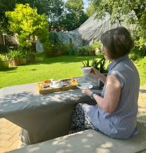 a woman sitting at a table with a plate of food at Joba-Rus in Bloemfontein +8 photos