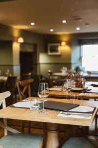 a wooden table with wine glasses on top of it at Bertram's in Warkworth +7 photos