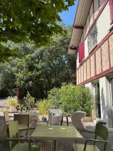a patio with tables and chairs and a building at Paloma in Hossegor