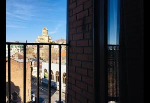 a view of a city from a window at Hotel New Royal in Tbilisi City