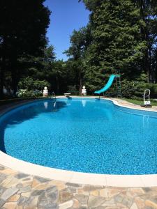 a swimming pool with a slide in the middle at Lake House in Vergiate